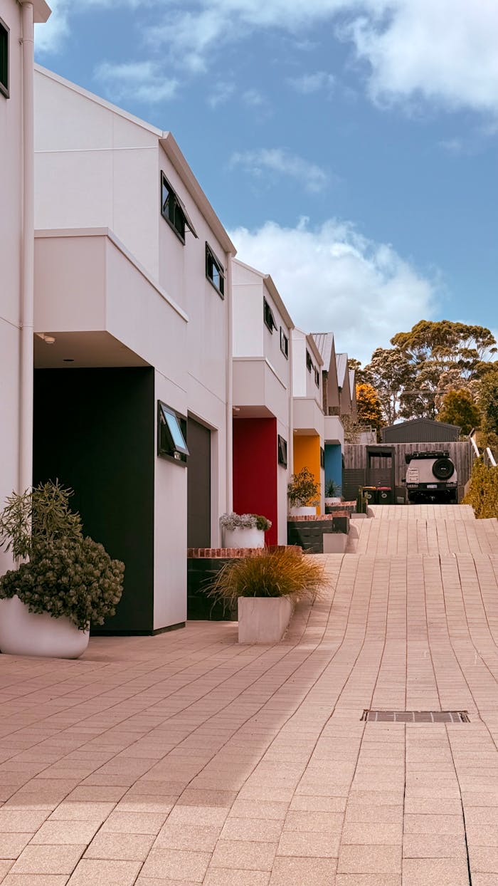A vibrant row of colorful townhouses under a bright blue sky, symbolizing modern urban living.